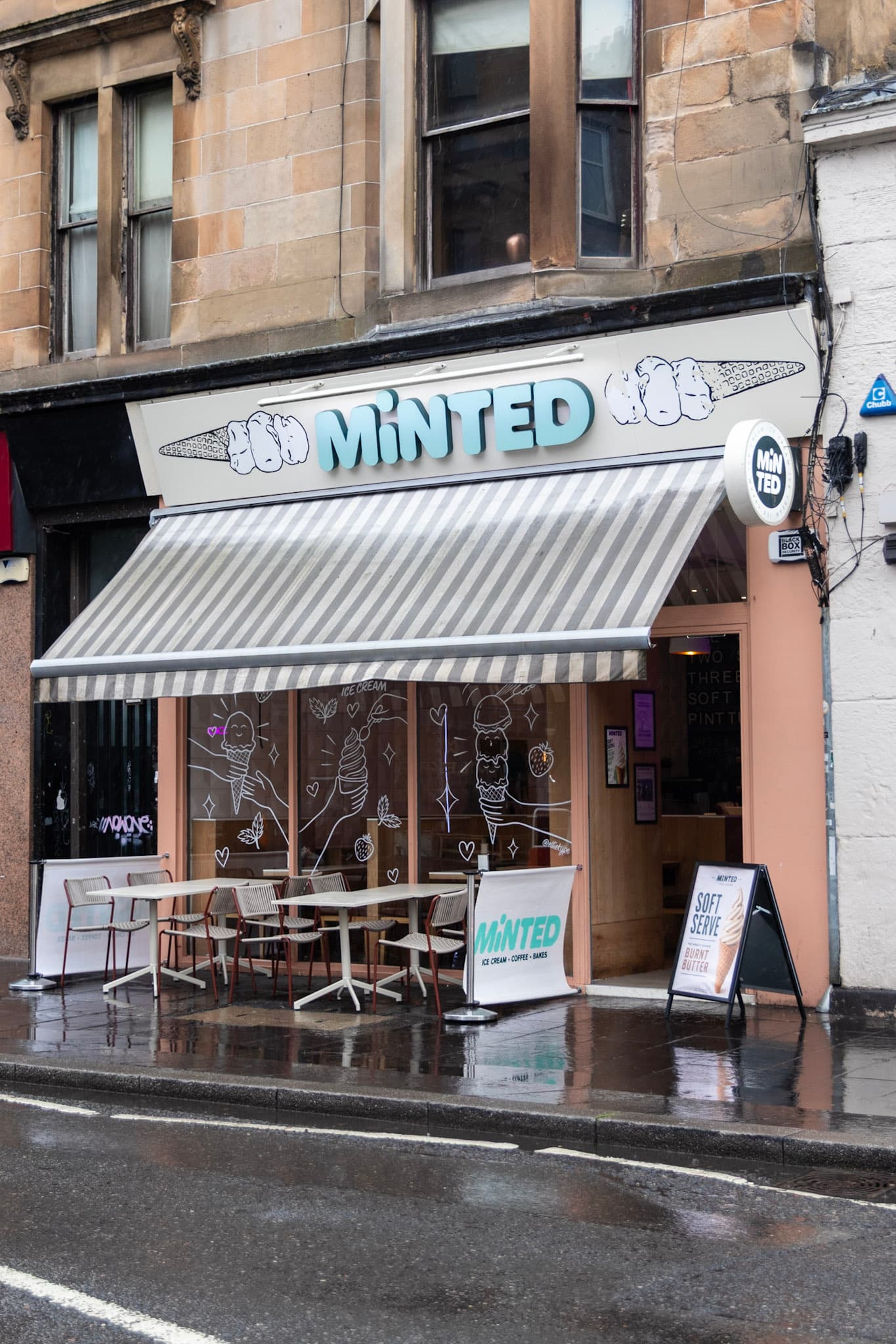 Minted Ice Cream shopfront on Byres Road, with the MINTED sign, striped awning, and pavement tables