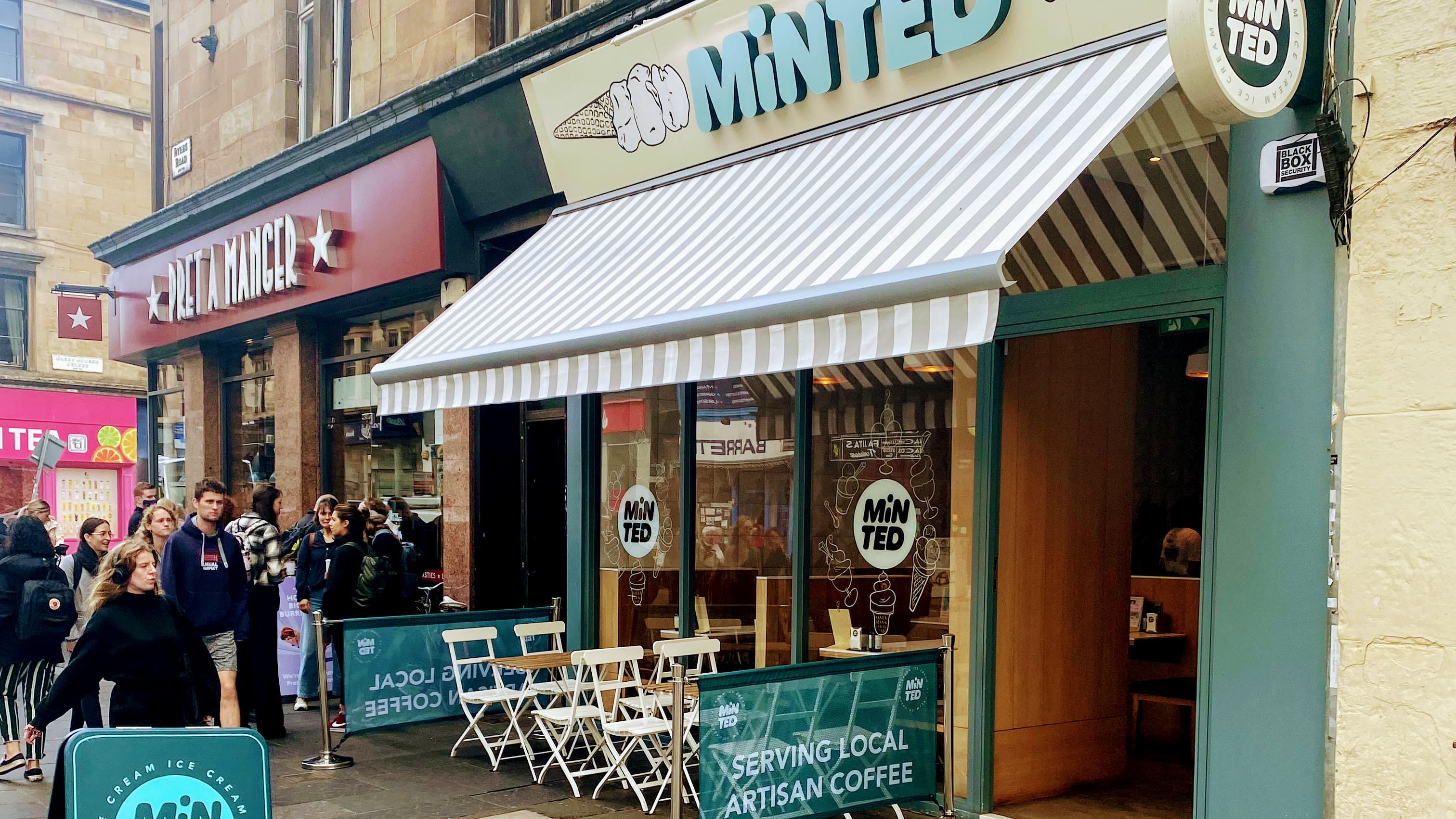 Minted Ice Cream shopfront on Byres Road, peach frames, striped awning, pavement tables